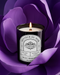 Pyneyard Rose Scented Candle with a label in front of a purple flower