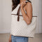 Person holding a Kleio White checkered tote bag with brown accents from Pyneyard